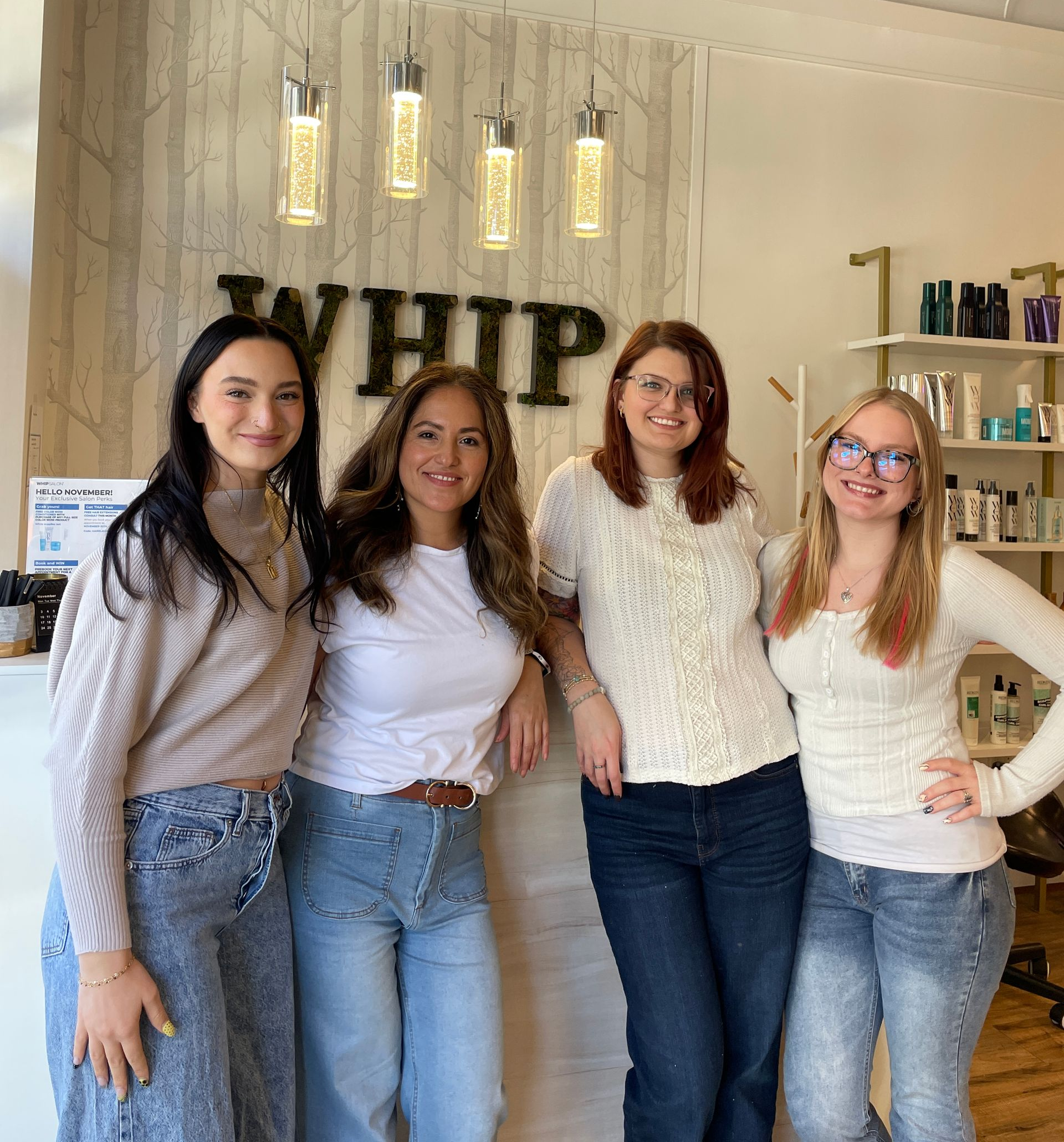 A group of women are posing for a picture in a salon.