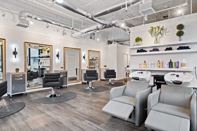 A hair salon with a lot of chairs and mirrors.