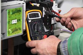 A Man Is Using A Digital Multimeter To Test An Electrical Circuit – Corowa, NSW - Mick Flynn Electrical Services