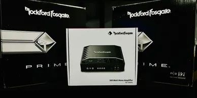 A rockford fosgate prime amplifier is sitting on top of a table.