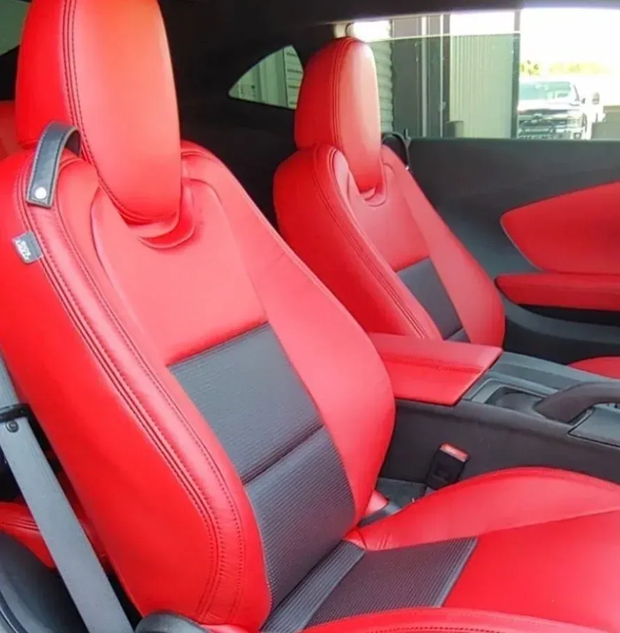 The interior of a car with red seats and black trim