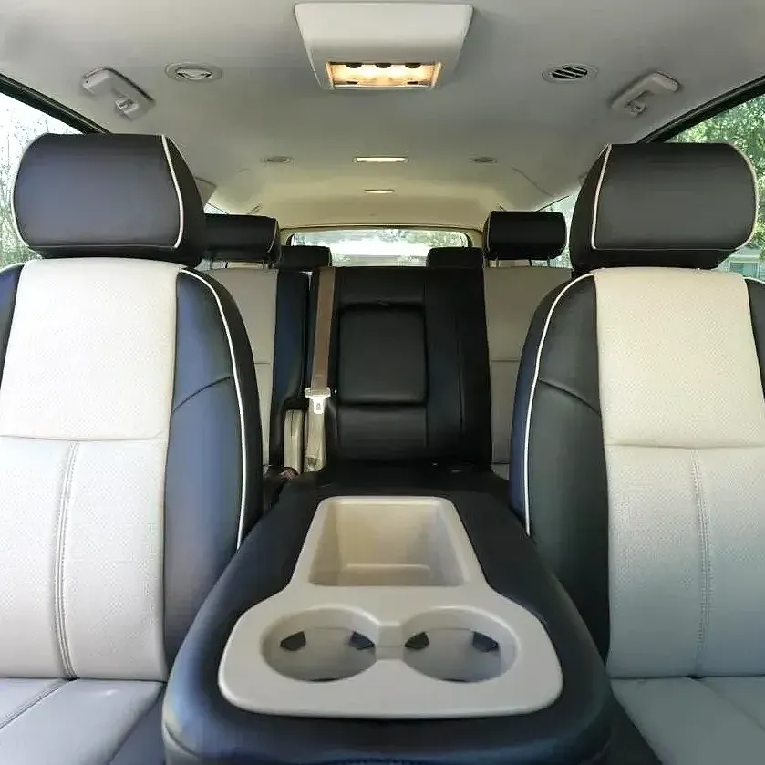 A car with black and white seats and a cup holder