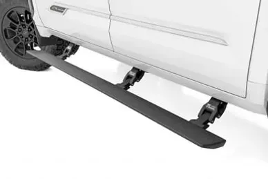 A white truck with black side steps on a white background.