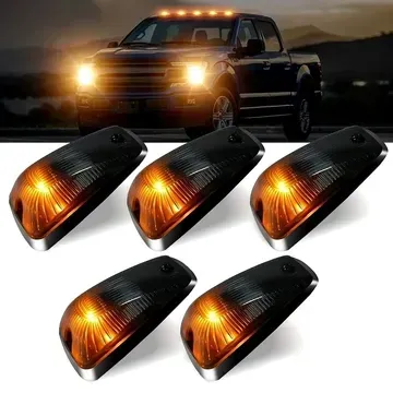 A black truck with amber lights on top of it