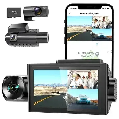 A dash cam is sitting next to a cell phone.