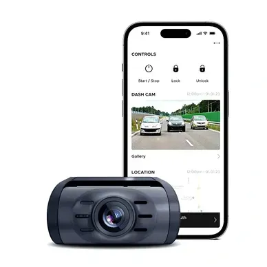 A dash cam is sitting next to a cell phone.