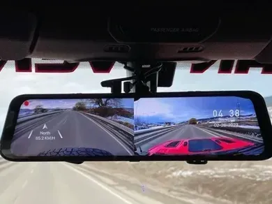 A car rear view mirror with a camera attached to it.