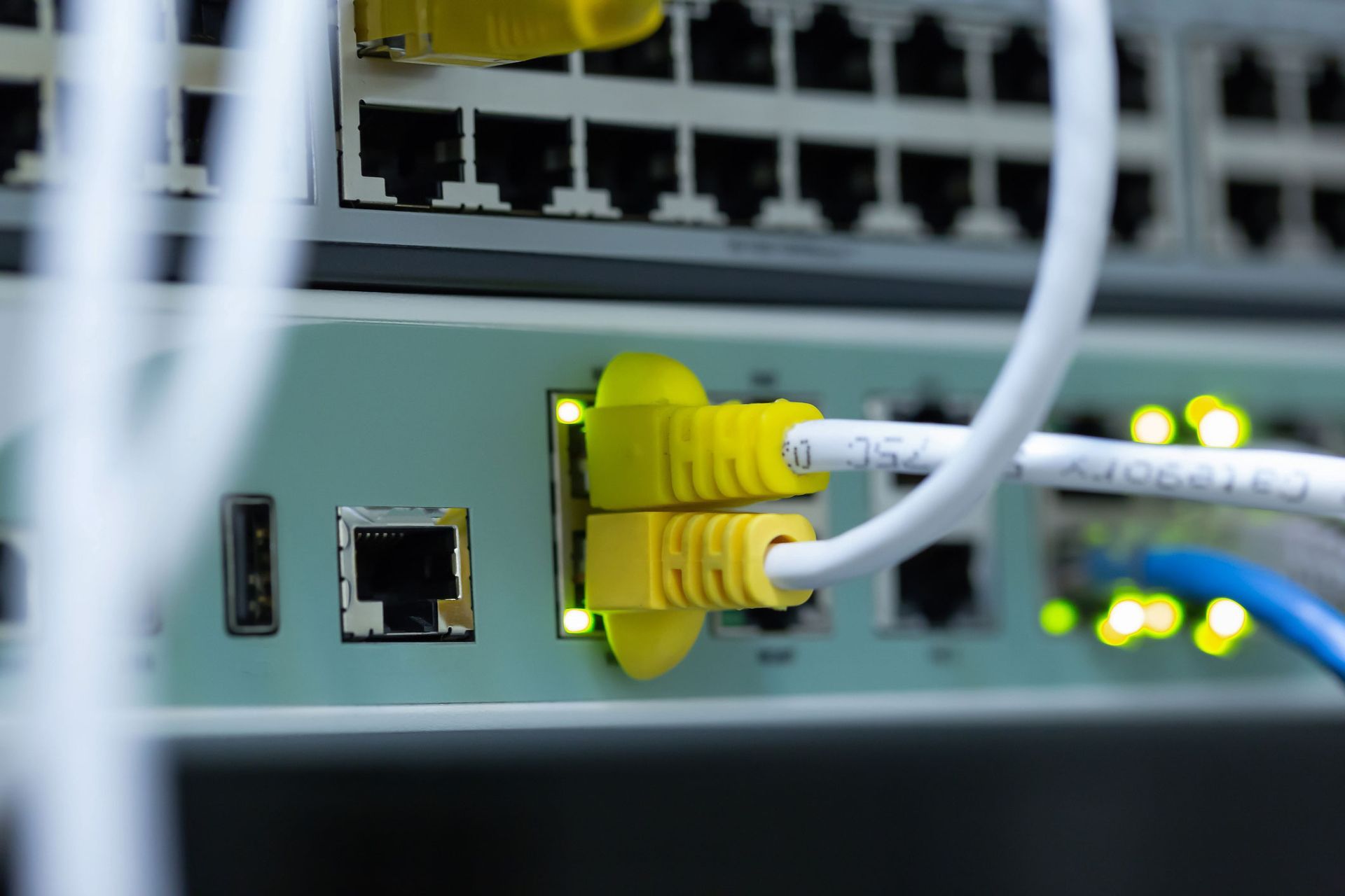 A bunch of wires are plugged into a server.