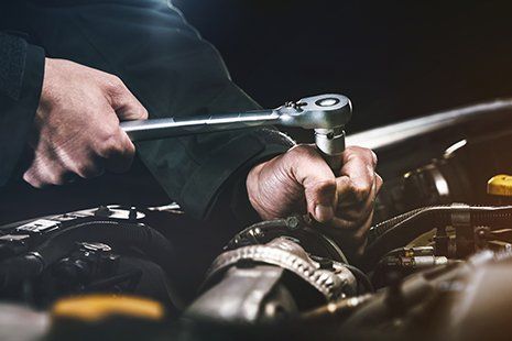 Transmission Repair — Auto Mechanic Working on a Car Engine in Detroit, MI