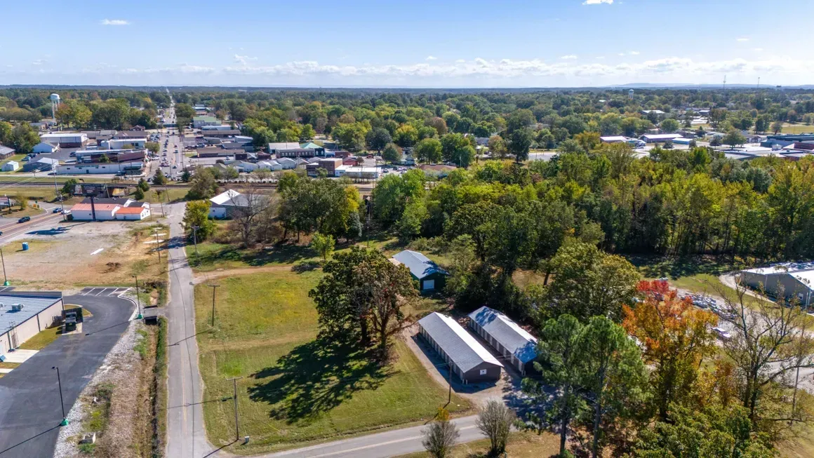 An aerial view of a small town with lots of trees and buildings.