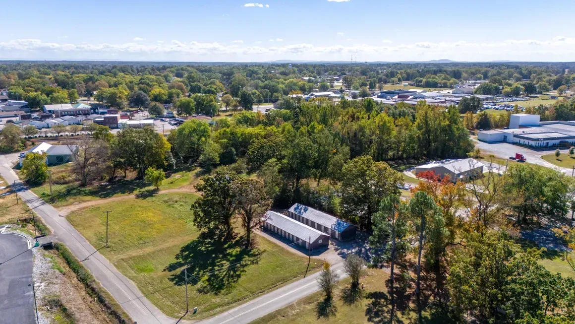 An aerial view of a residential area with lots of trees and buildings.