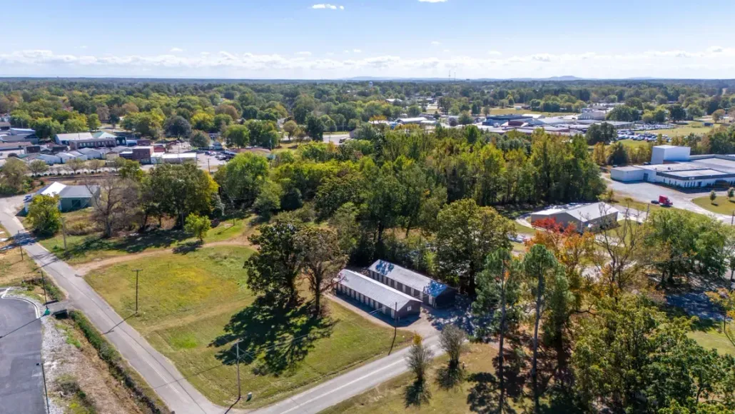 An aerial view of a residential area with lots of trees and buildings.