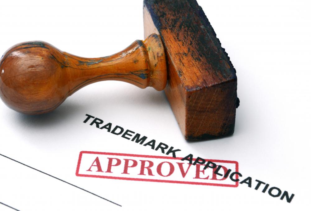 A trademark application is approved with a wooden stamp