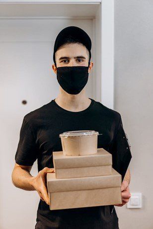 Delivery boy with food boxes