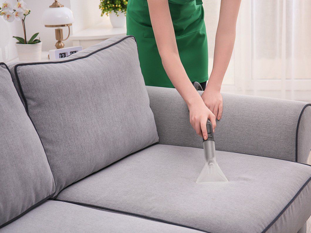 Woman Cleaning Couch Upholstery