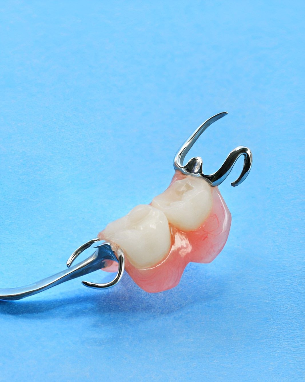 A Close Up of a Denture on a Blue Surface — Yeppoon Denture Clinic in Taranganba, QLD