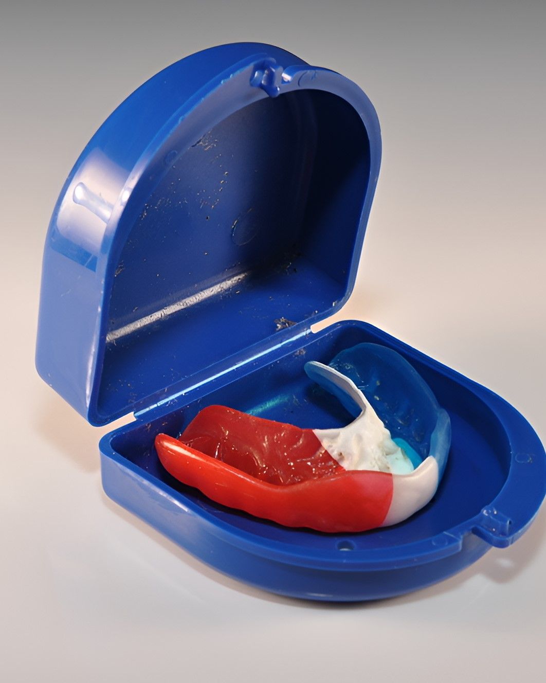 A Red White and Blue Mouth Guard in a Blue Case — Yeppoon Denture Clinic in Taranganba, QLD