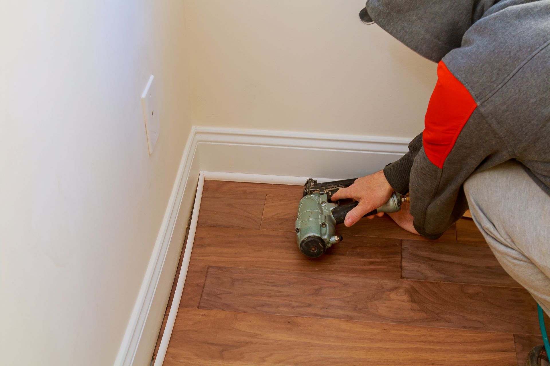 installing baseboards with a nailgun