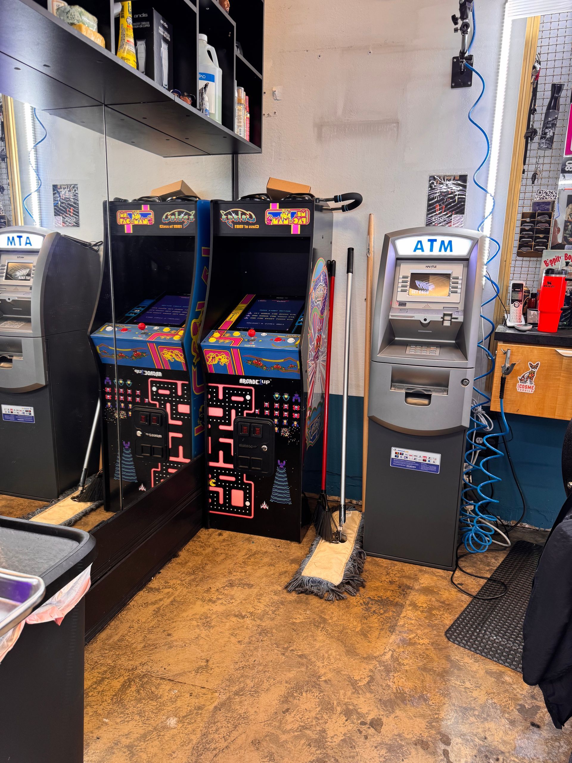 A room with two atm machines and two arcade machines