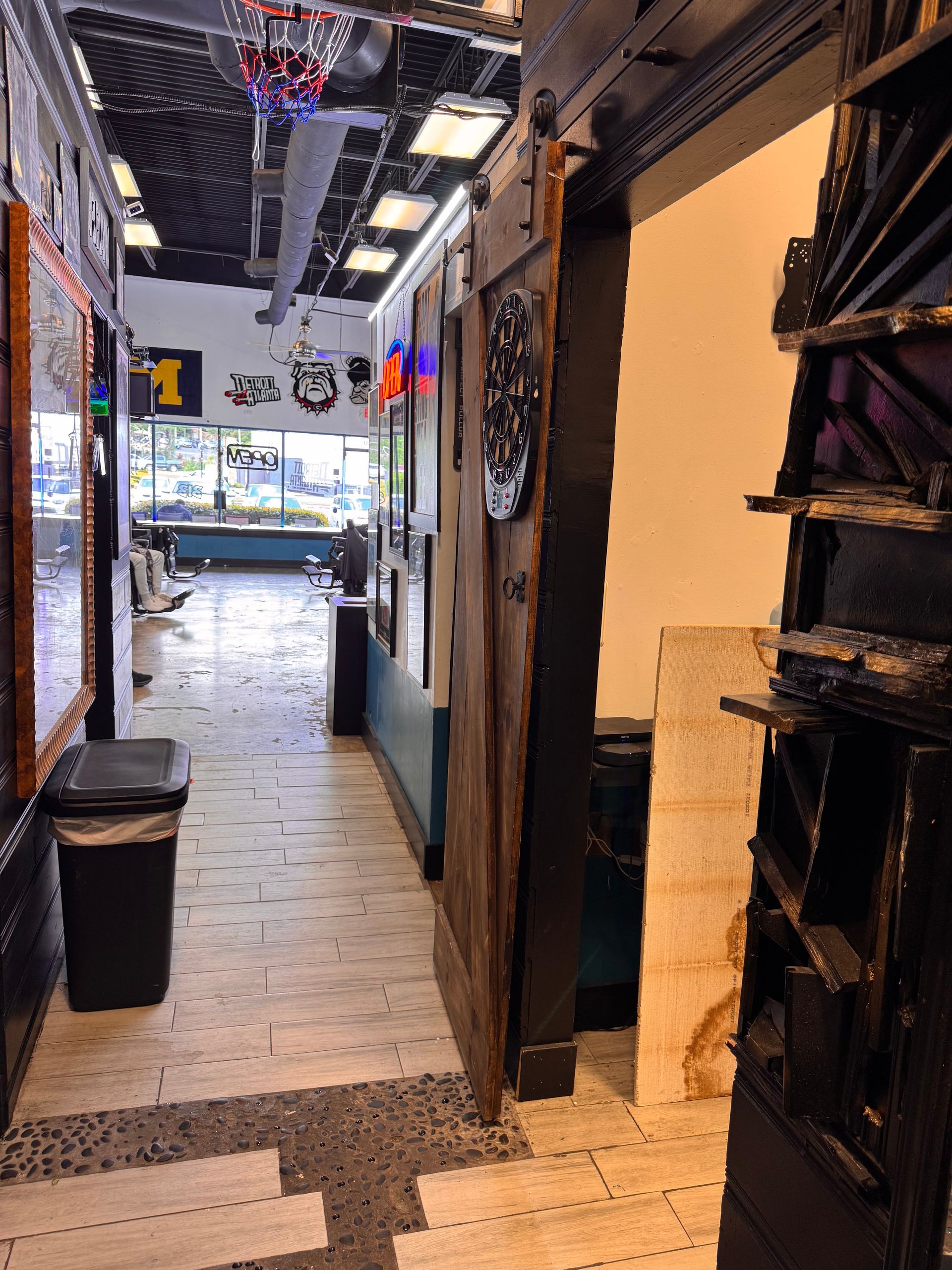 A long hallway in a building with a trash can in the middle