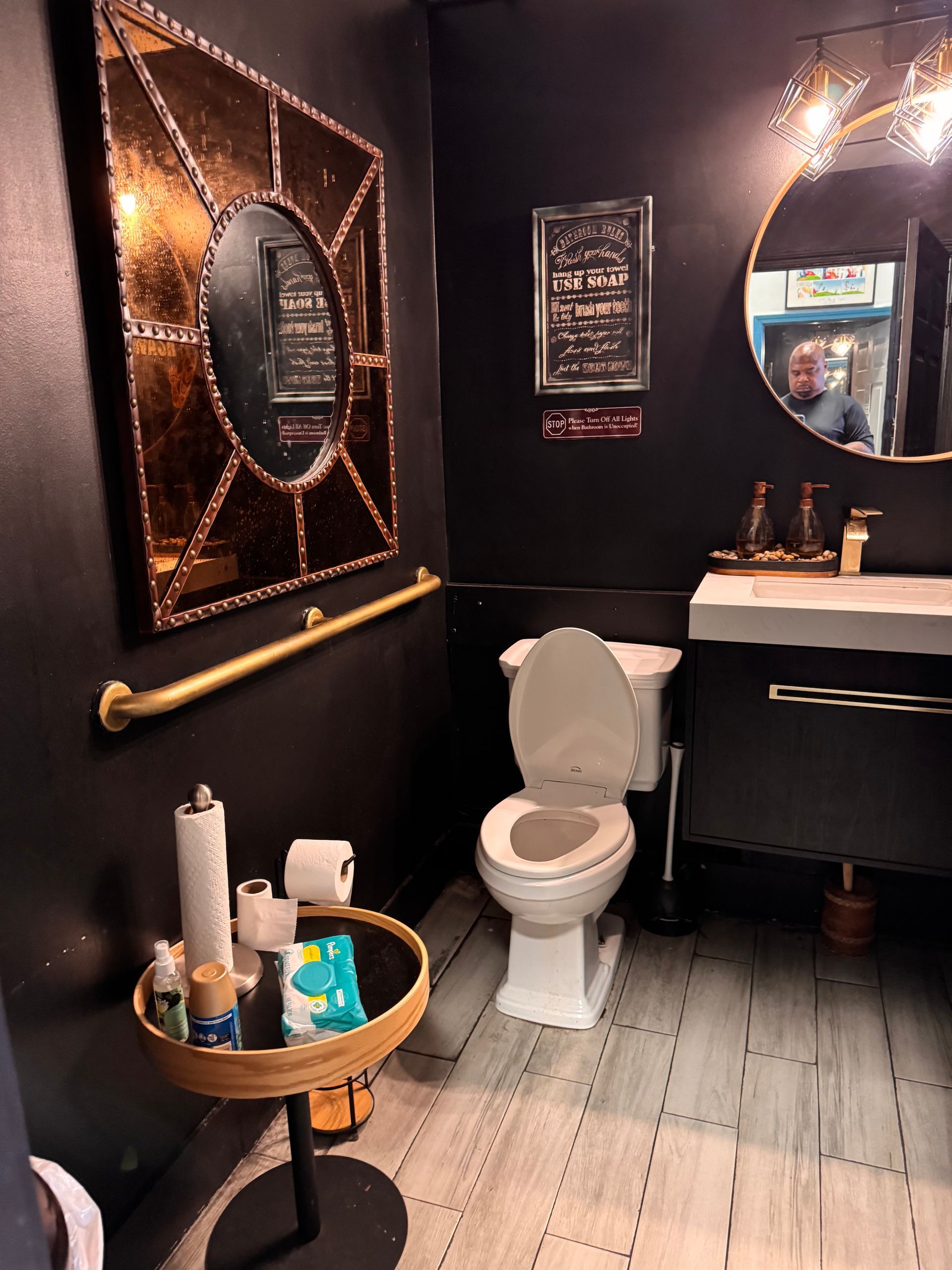 A bathroom with a toilet a sink and a mirror