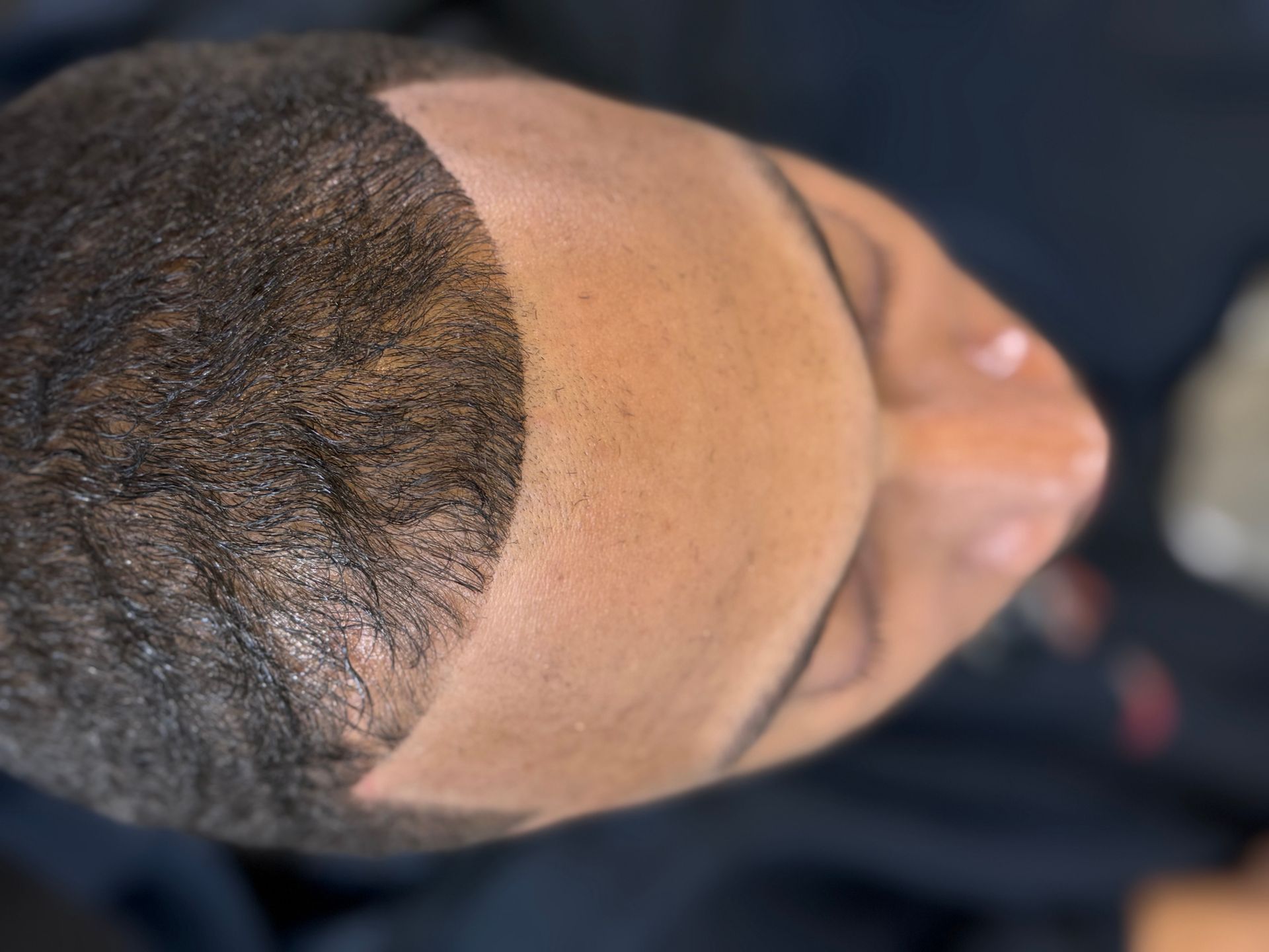 A close up of a man 's face with his eyes closed