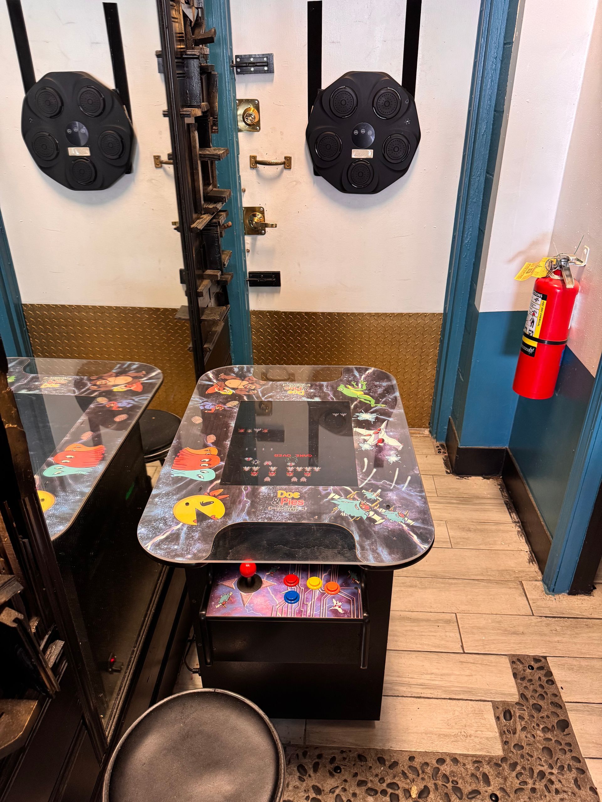 A room with a table and a fire extinguisher on the wall