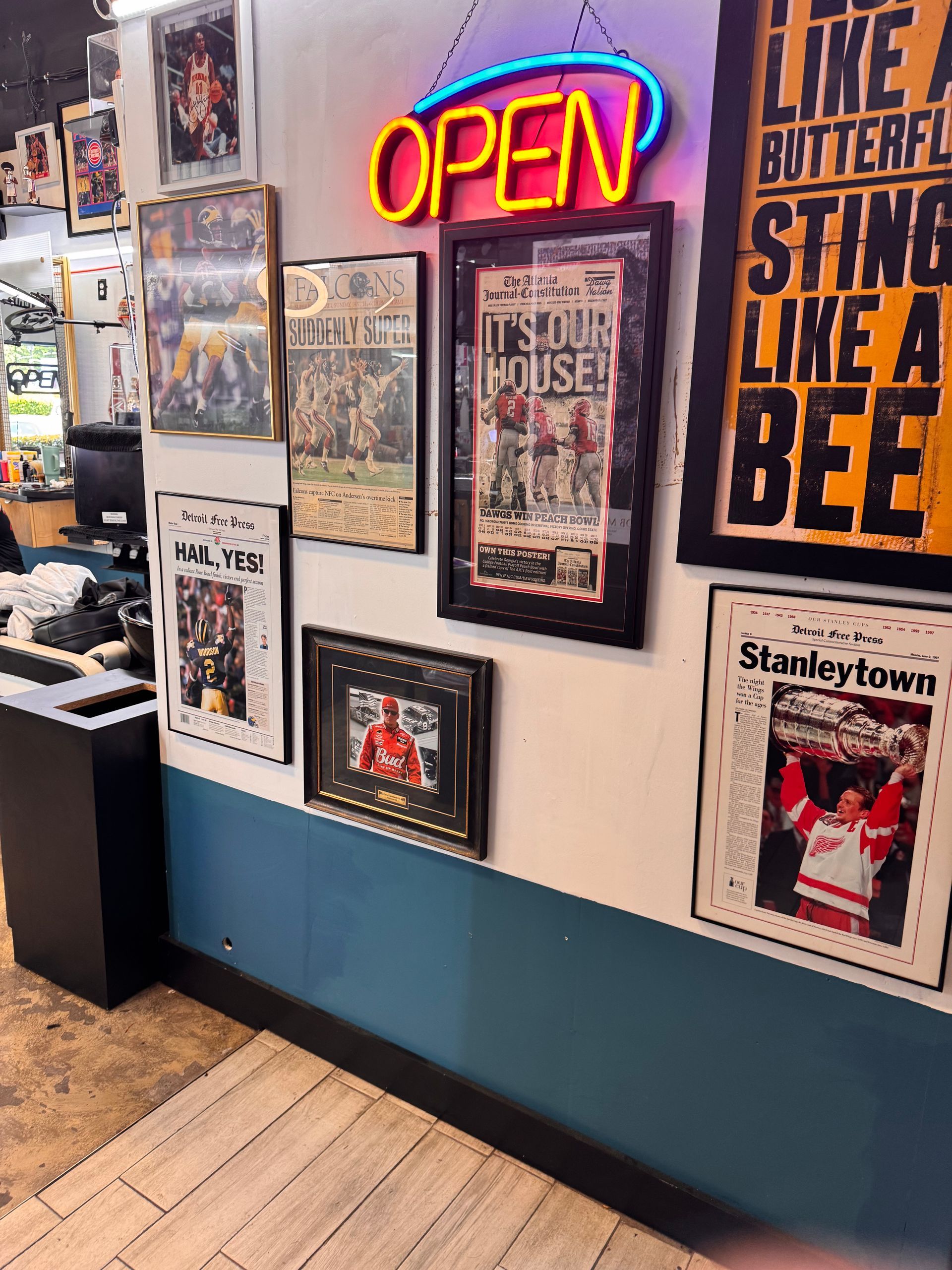 A neon sign that says open is hanging on a wall