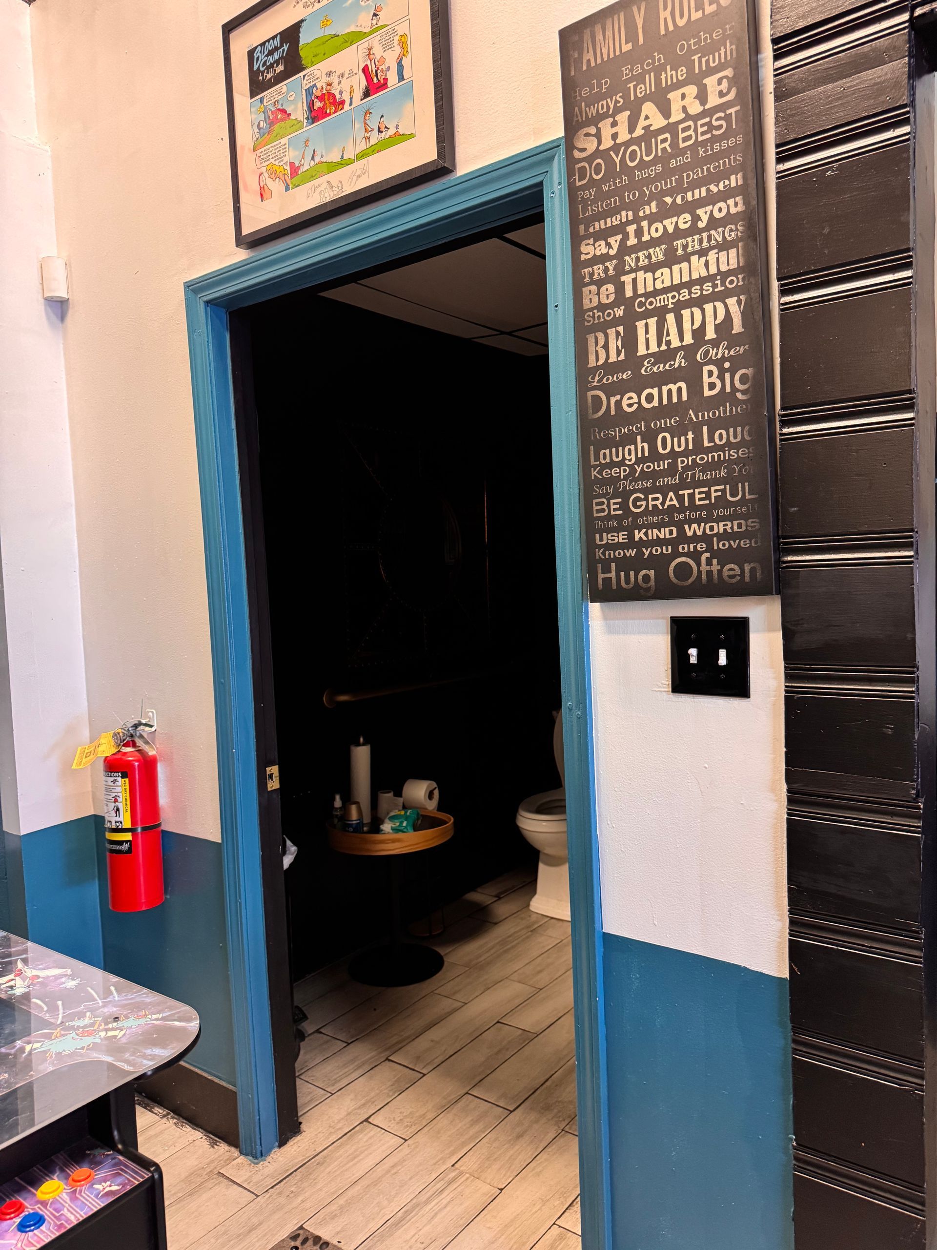 A bathroom with a sign on the wall that says `` be happy ''.