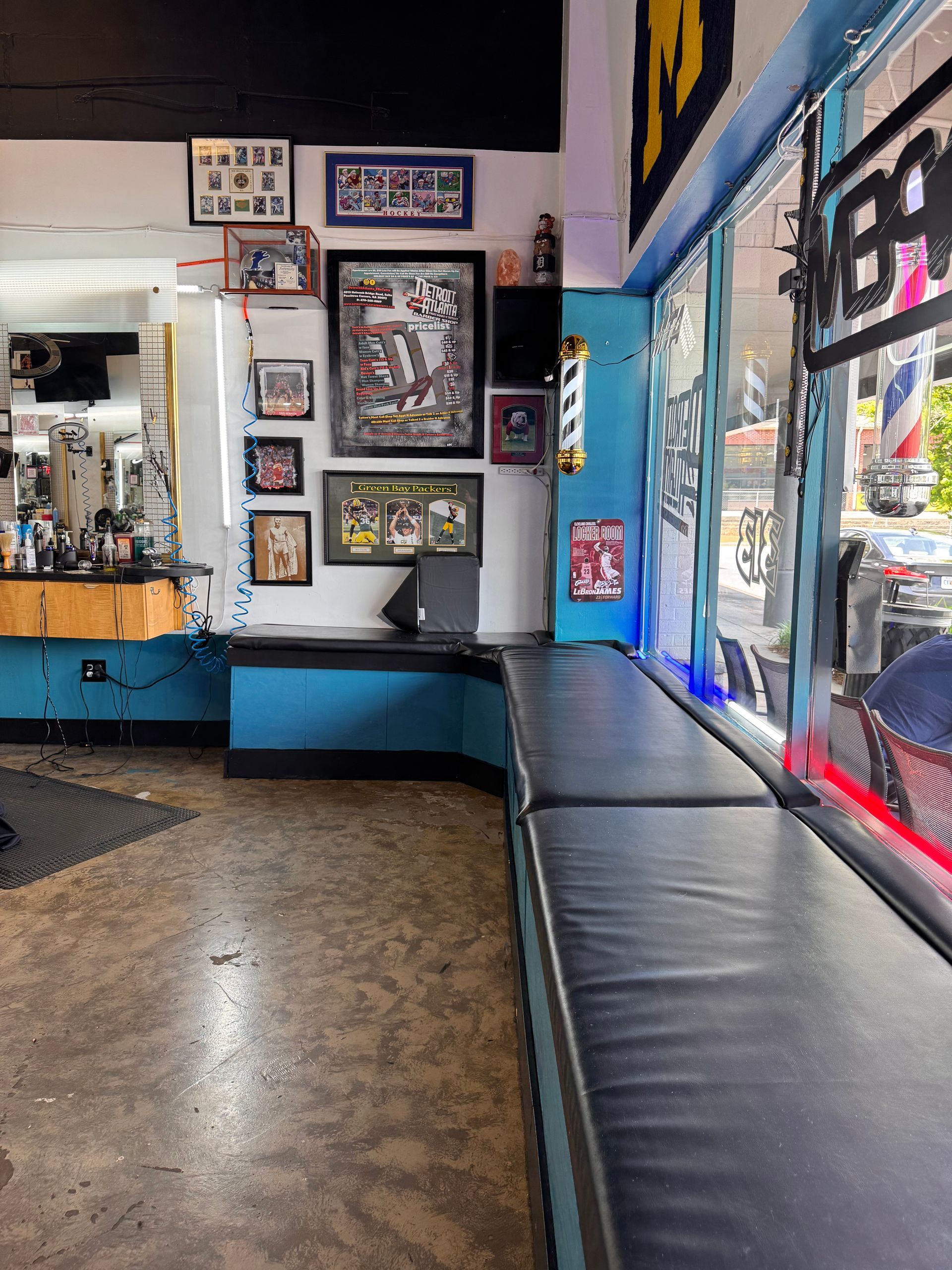 A barber shop with a lot of pictures on the wall