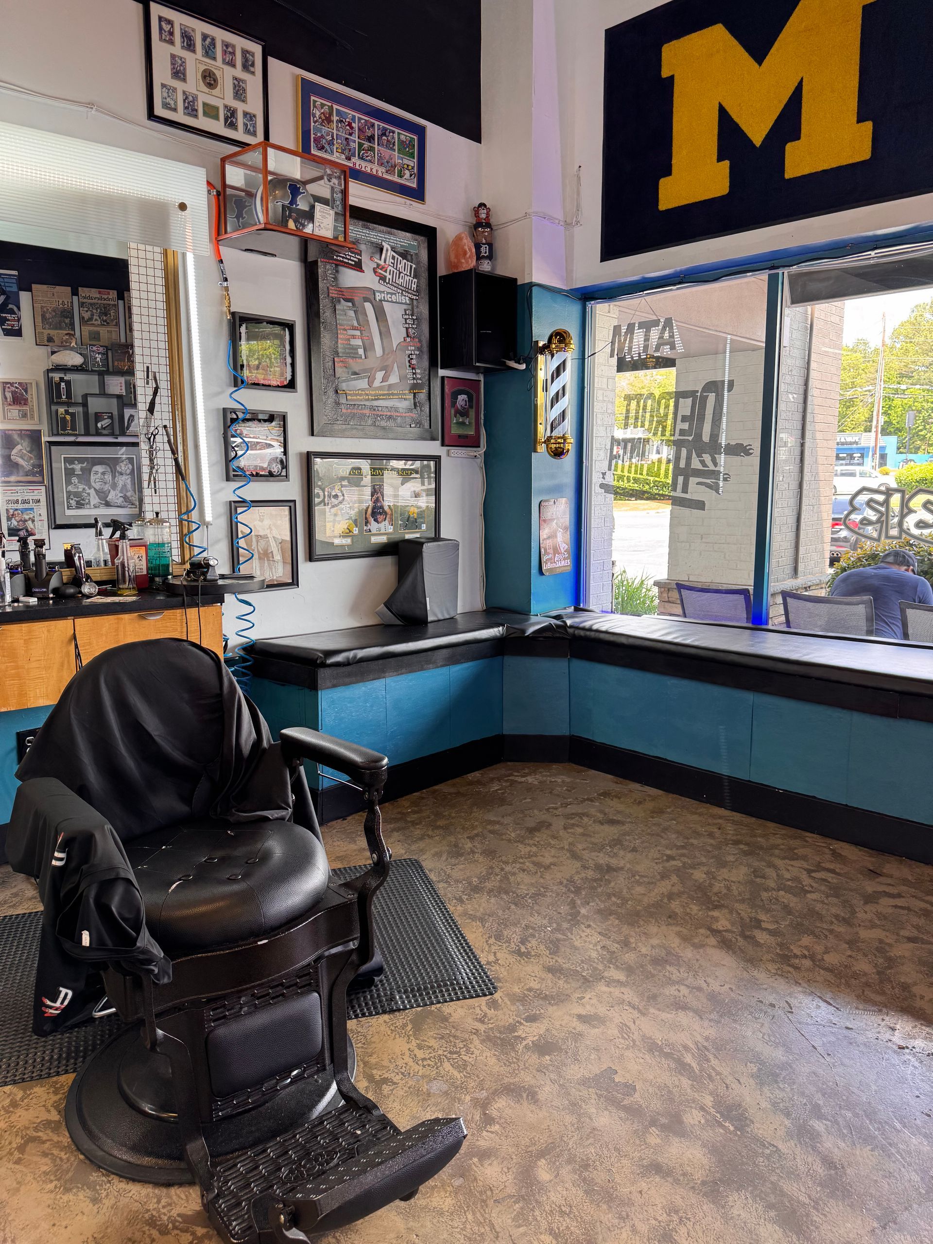 A barber shop with a large m on the wall