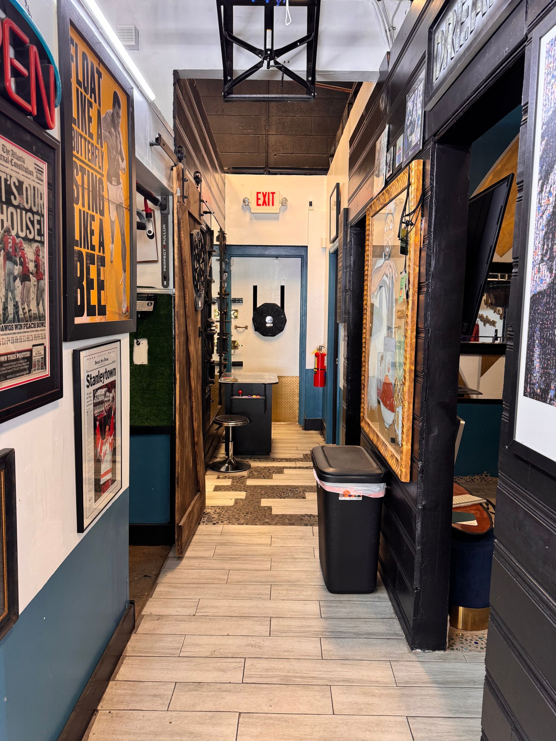 A long hallway with a sign on the wall that says exit
