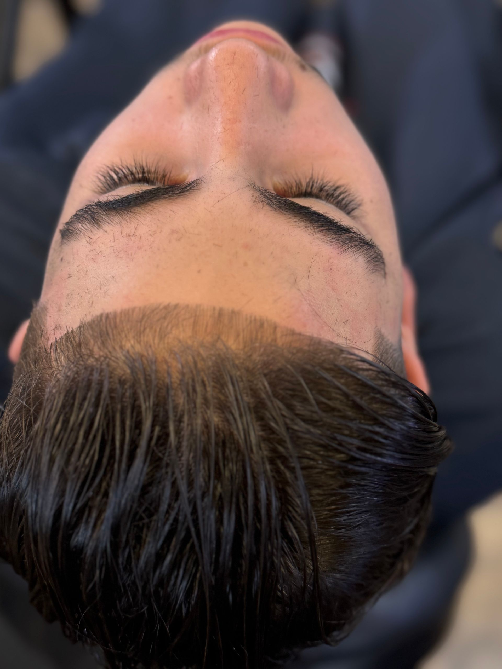 A close up of a man 's face with his eyes closed