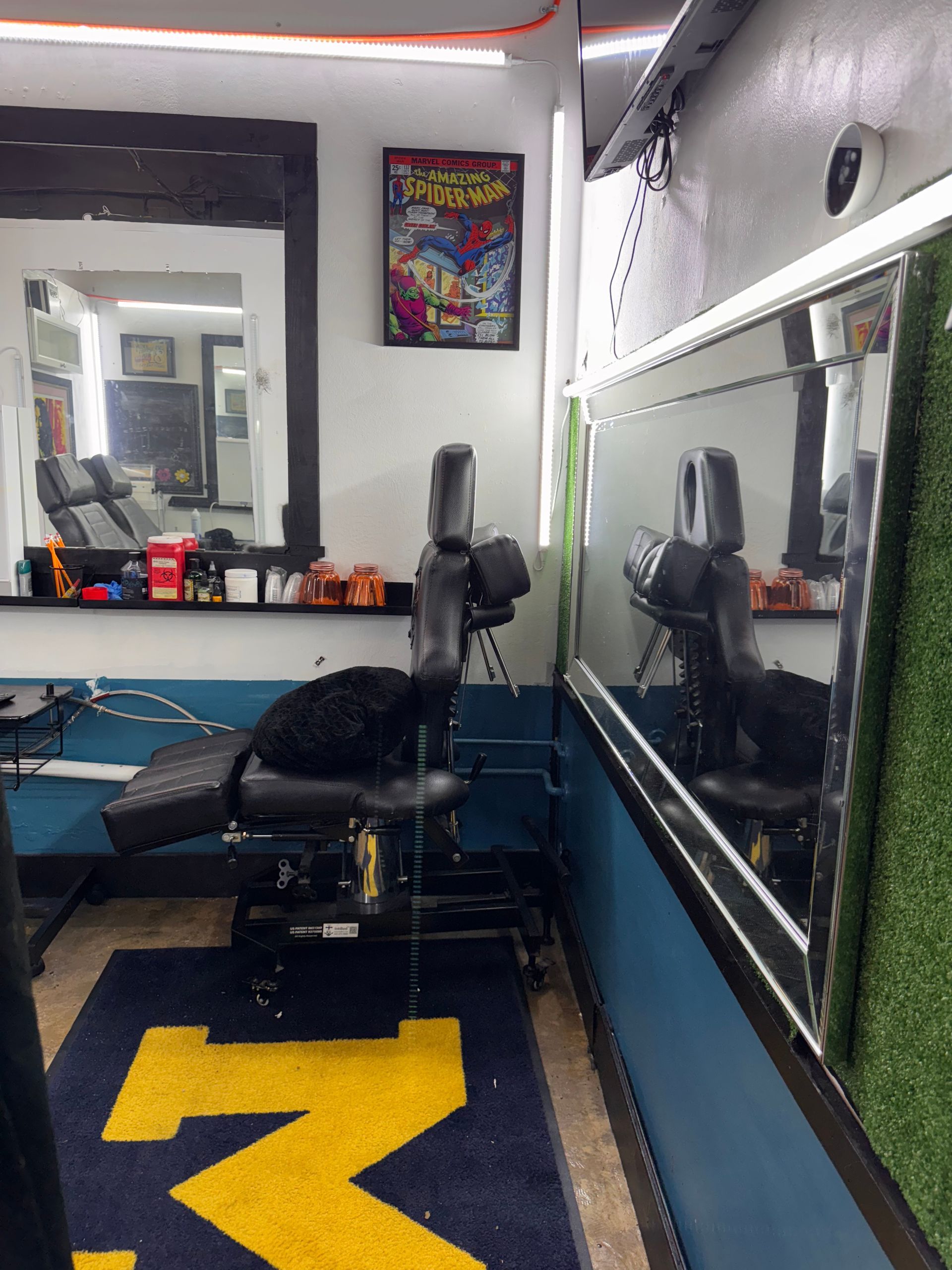 A room with a chair and a rug with the letter m on it