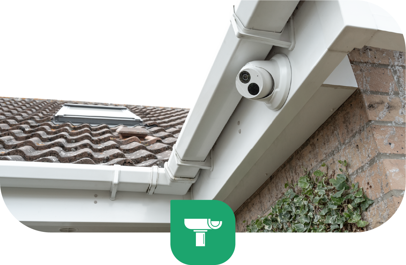 Security camera mounted on a white fascia board, overlooking a roof with brown tiles.