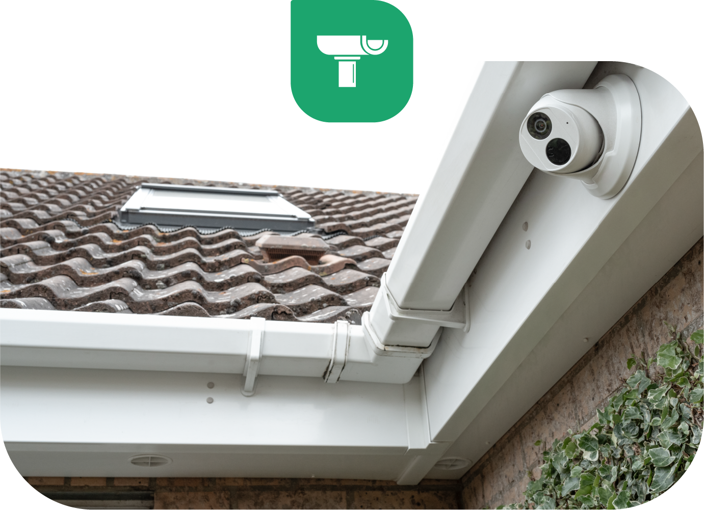 Security camera mounted on a white gutter, overlooking a tiled roof. A green icon of a camera is in the top left corner.