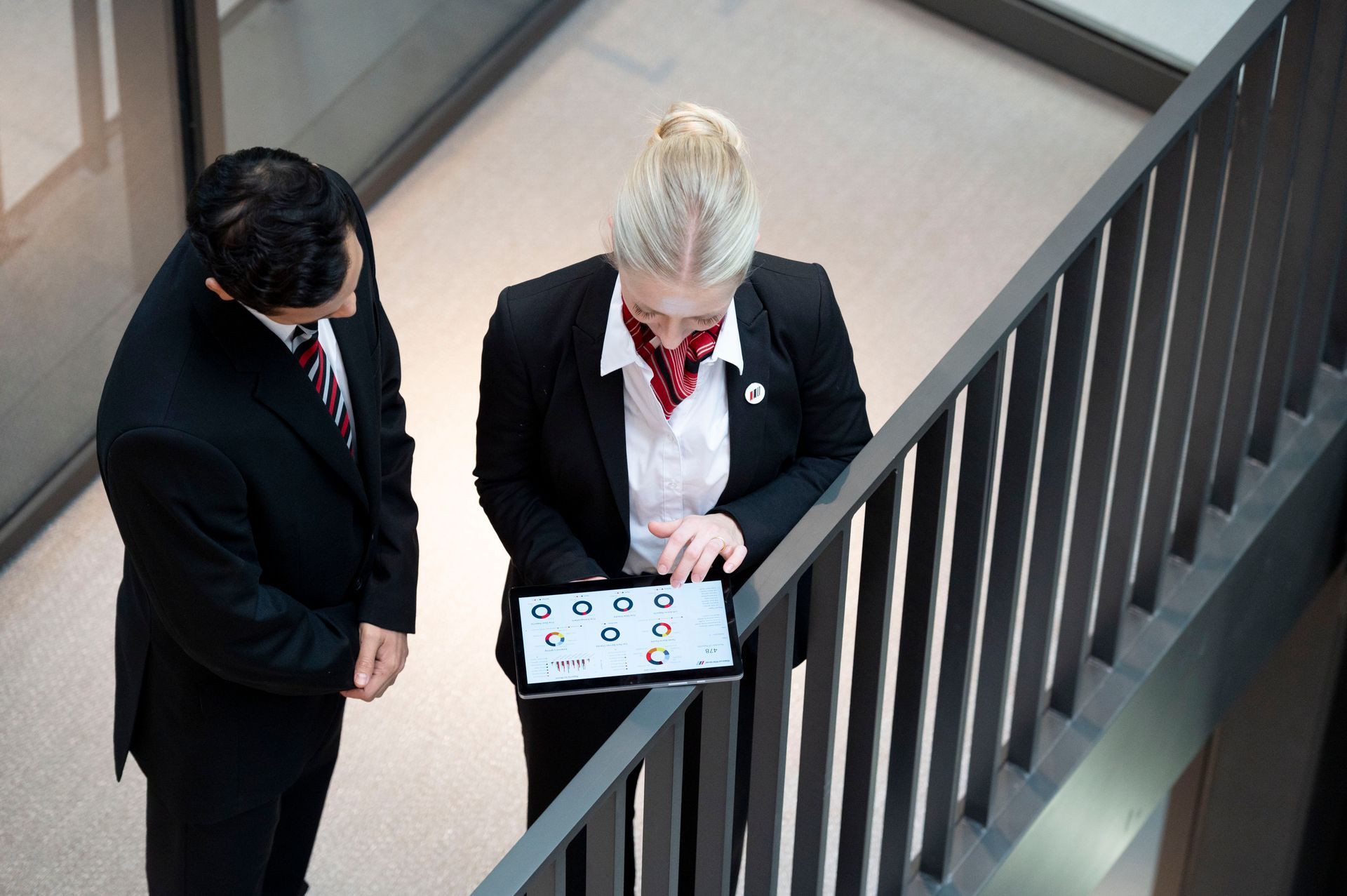A man and a woman are looking at a tablet together