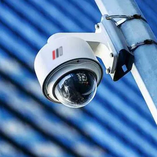 A security camera is mounted on a pole.