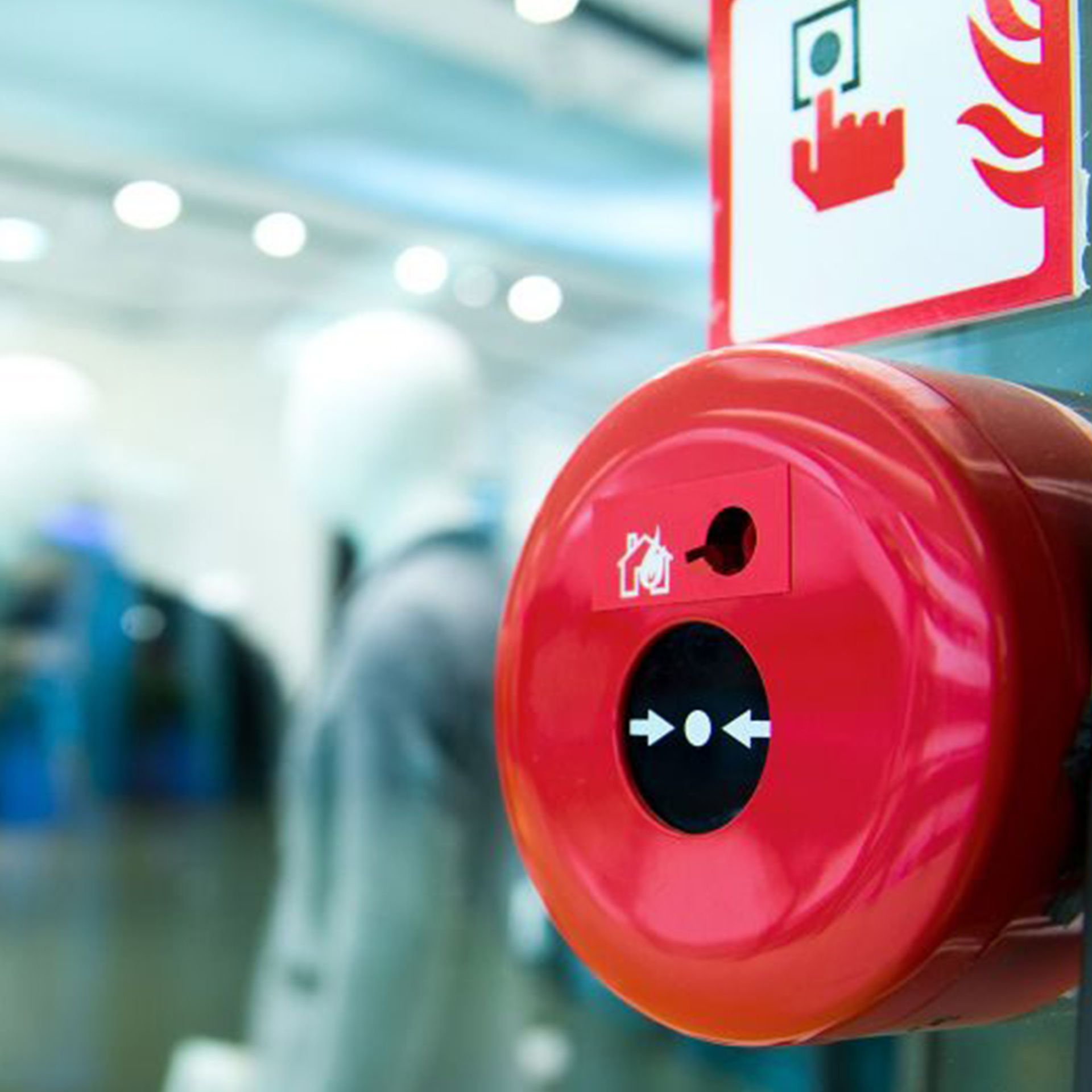 A red fire alarm with a sign above it