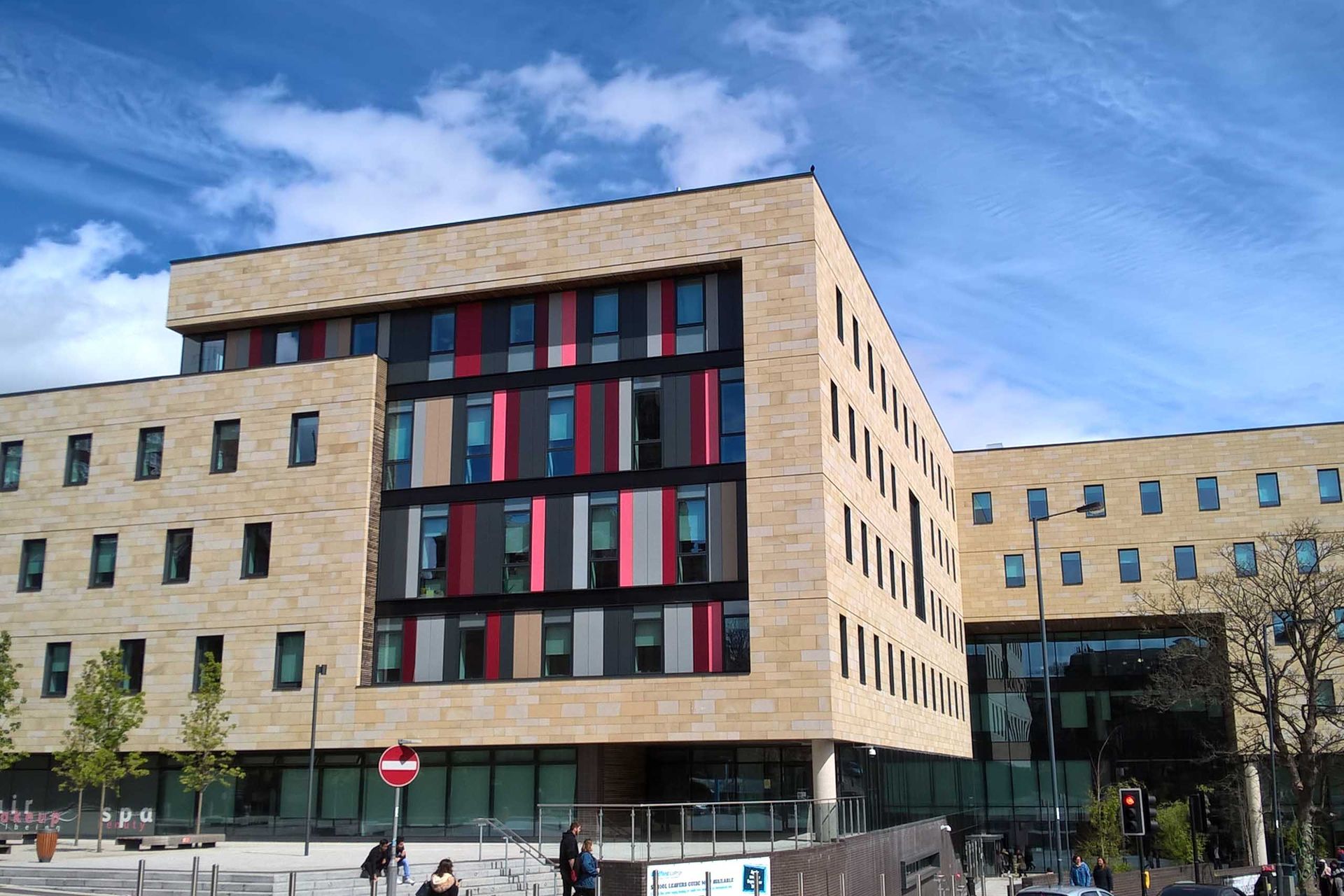 A large brick building with a lot of windows on a sunny day