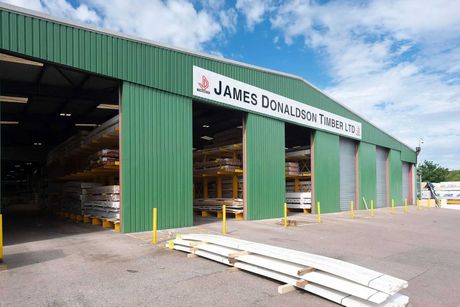 A large green building with a sign that says janes dovalescent timber ltd