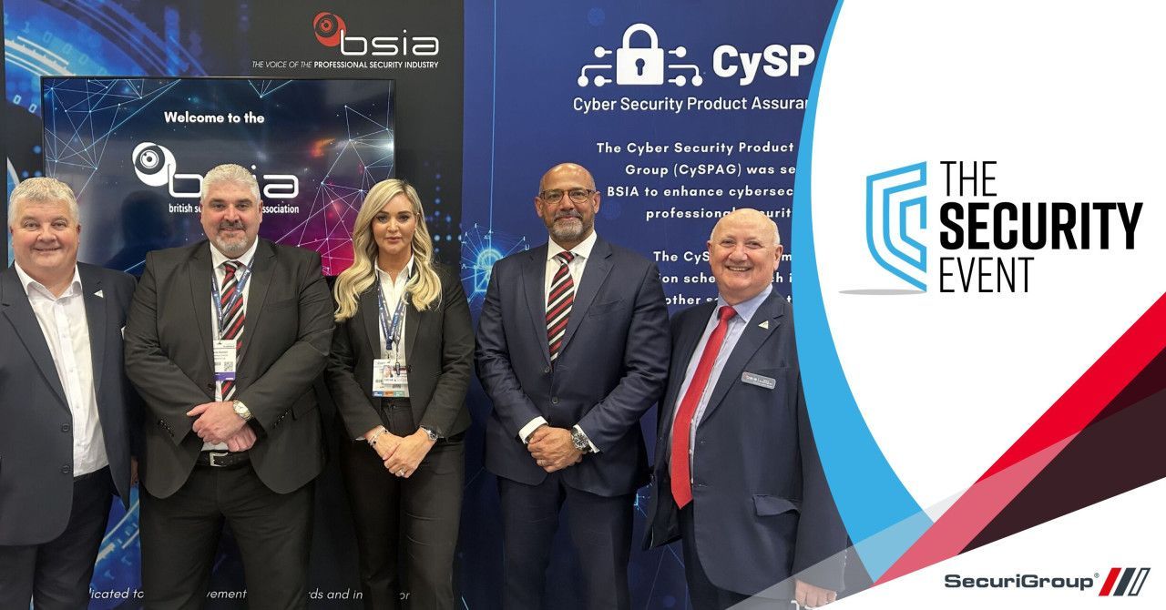 A group of people standing in front of a sign that says the security event