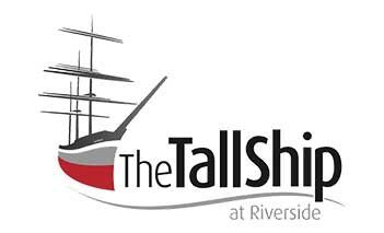 Logo of The TallShip at Riverside: sailing ship graphic with black text and red accent.