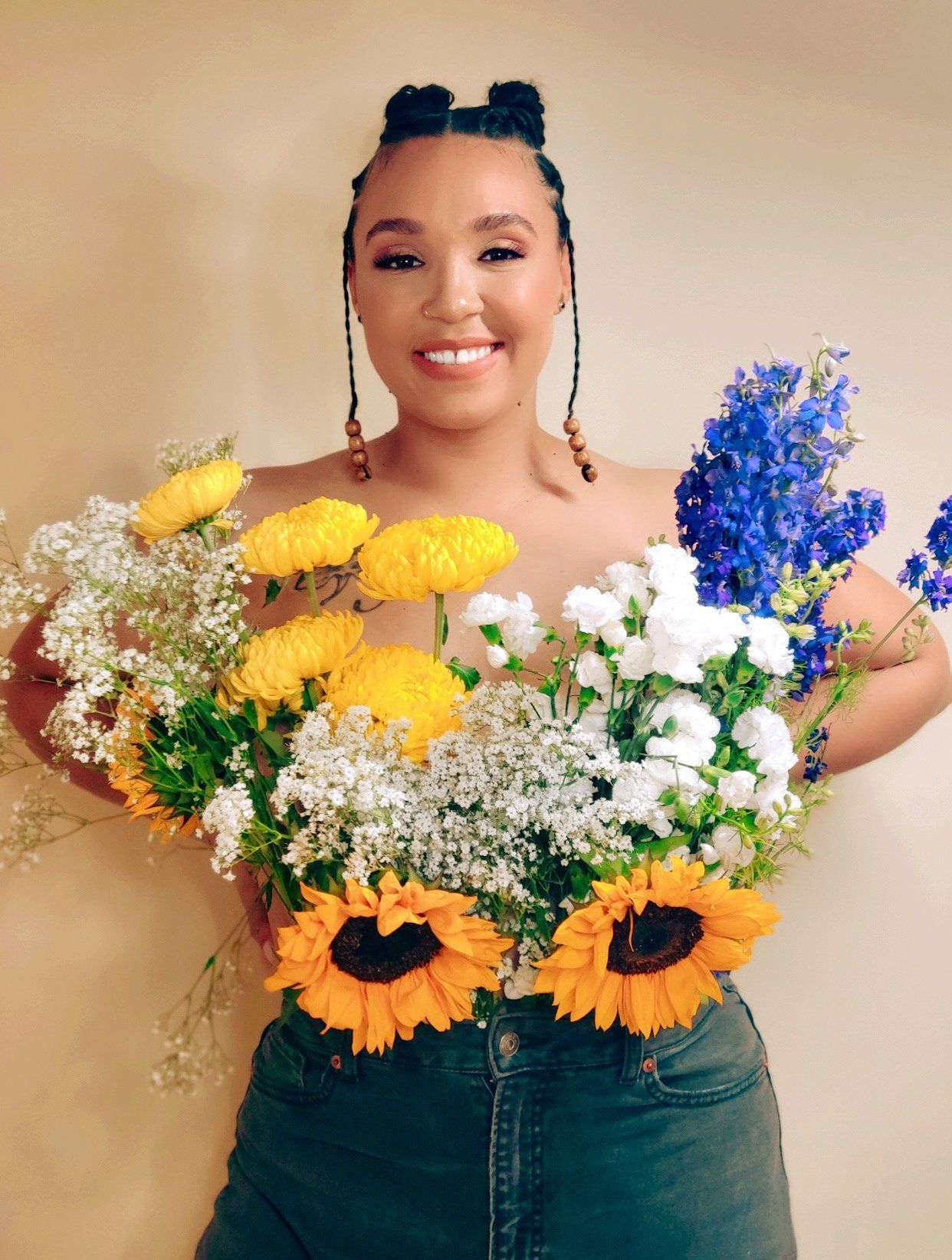 A woman is holding a bouquet of flowers in her hands.