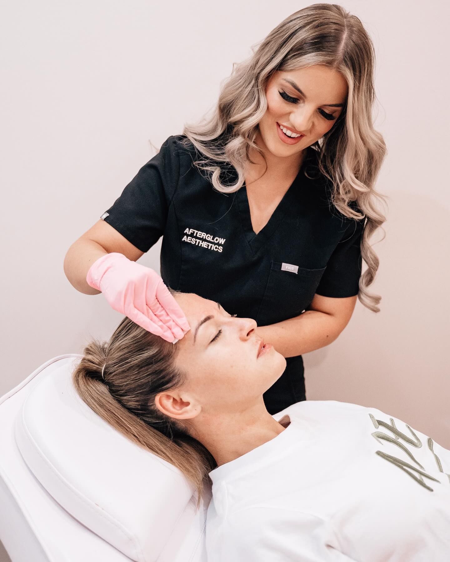 Renee Seneca at Afterglow Aesthetics clinic with a client getting a treatment