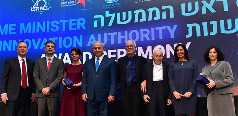 CEO Eran Baniel and Founder Avraham Baniel at an award ceremony standing beside Israel's Prime Minister Mr Benjamin Netanyahu