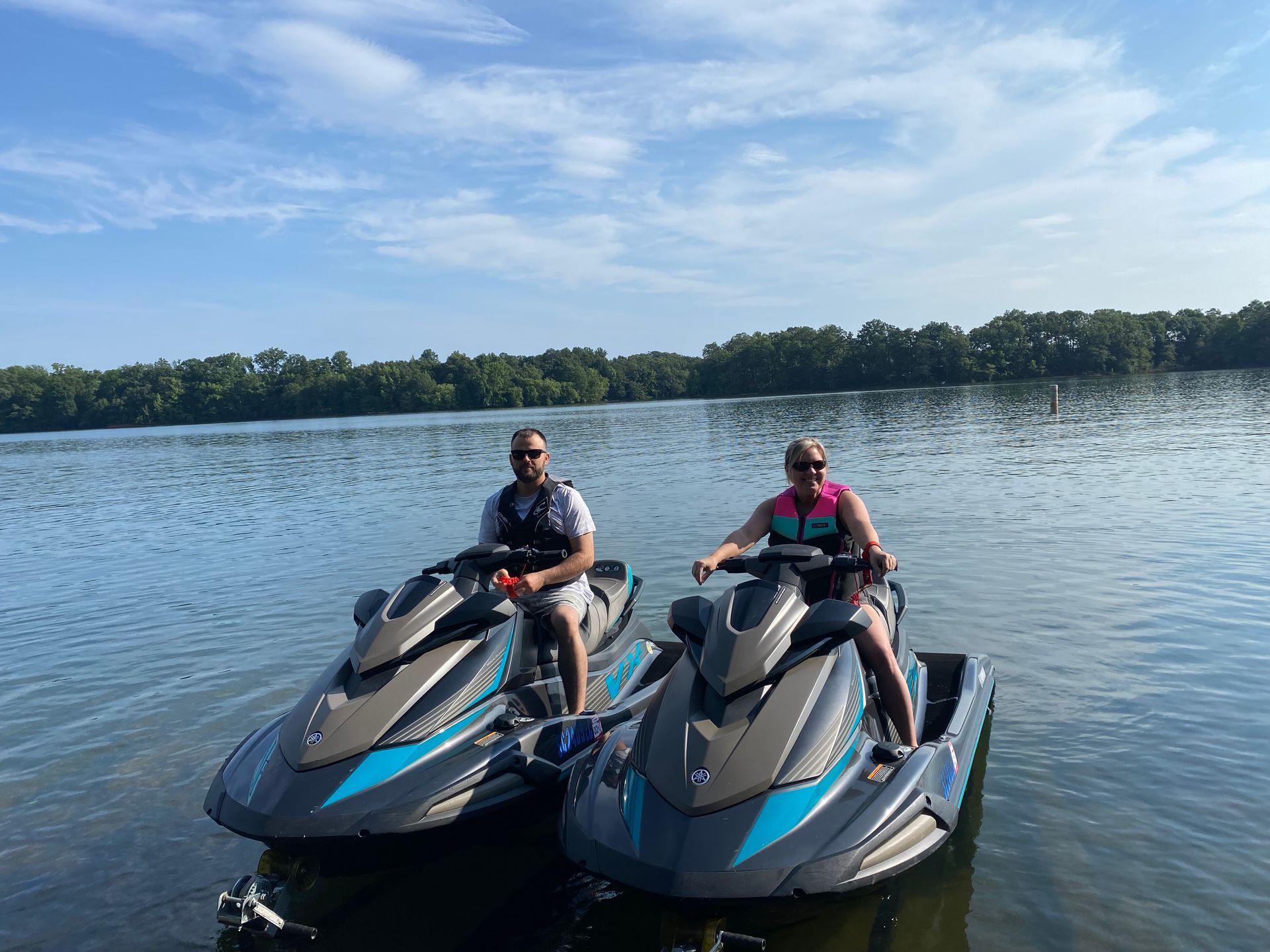 Two people are riding fast jet ski rentals from Sea Jay Powersports on Lake Keowee