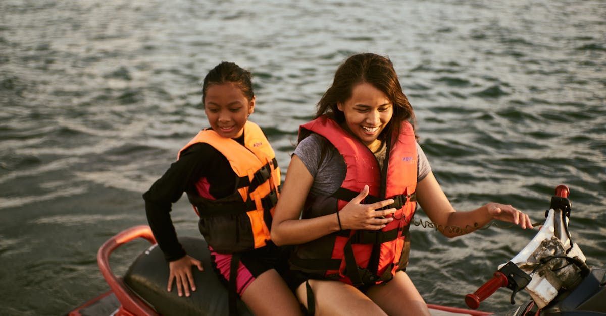 Two girls are riding a jet ski rental on Lake Hartwell.