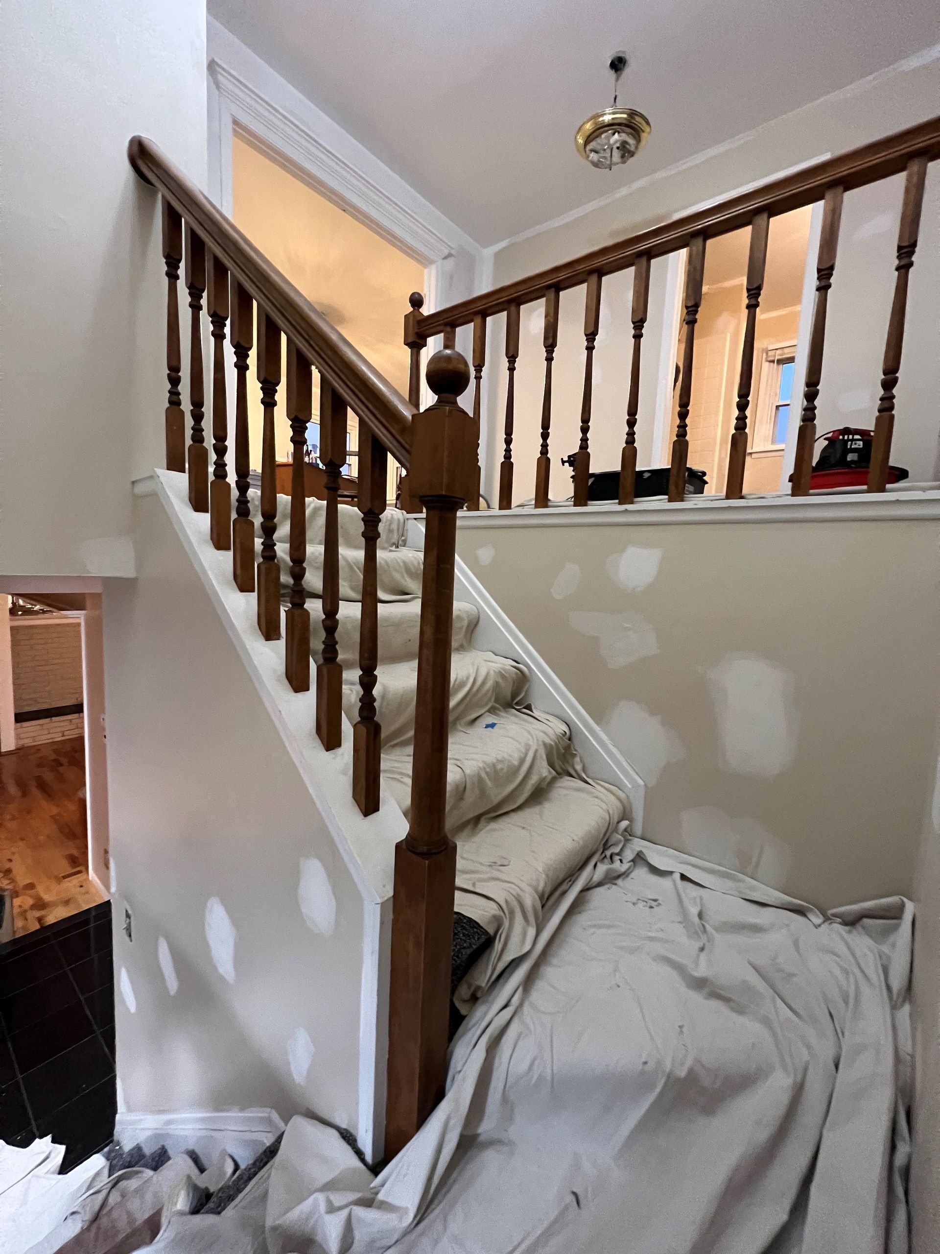 A staircase in a house that is being painted