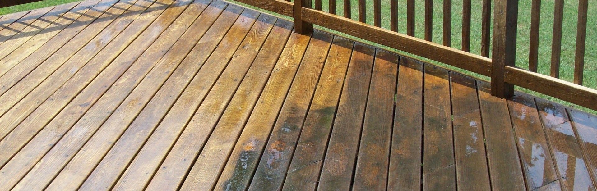 A wooden deck with a fence in the background.